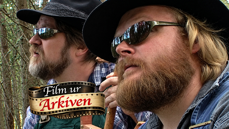 Två män i profil med skägg, solglasögon och hatt